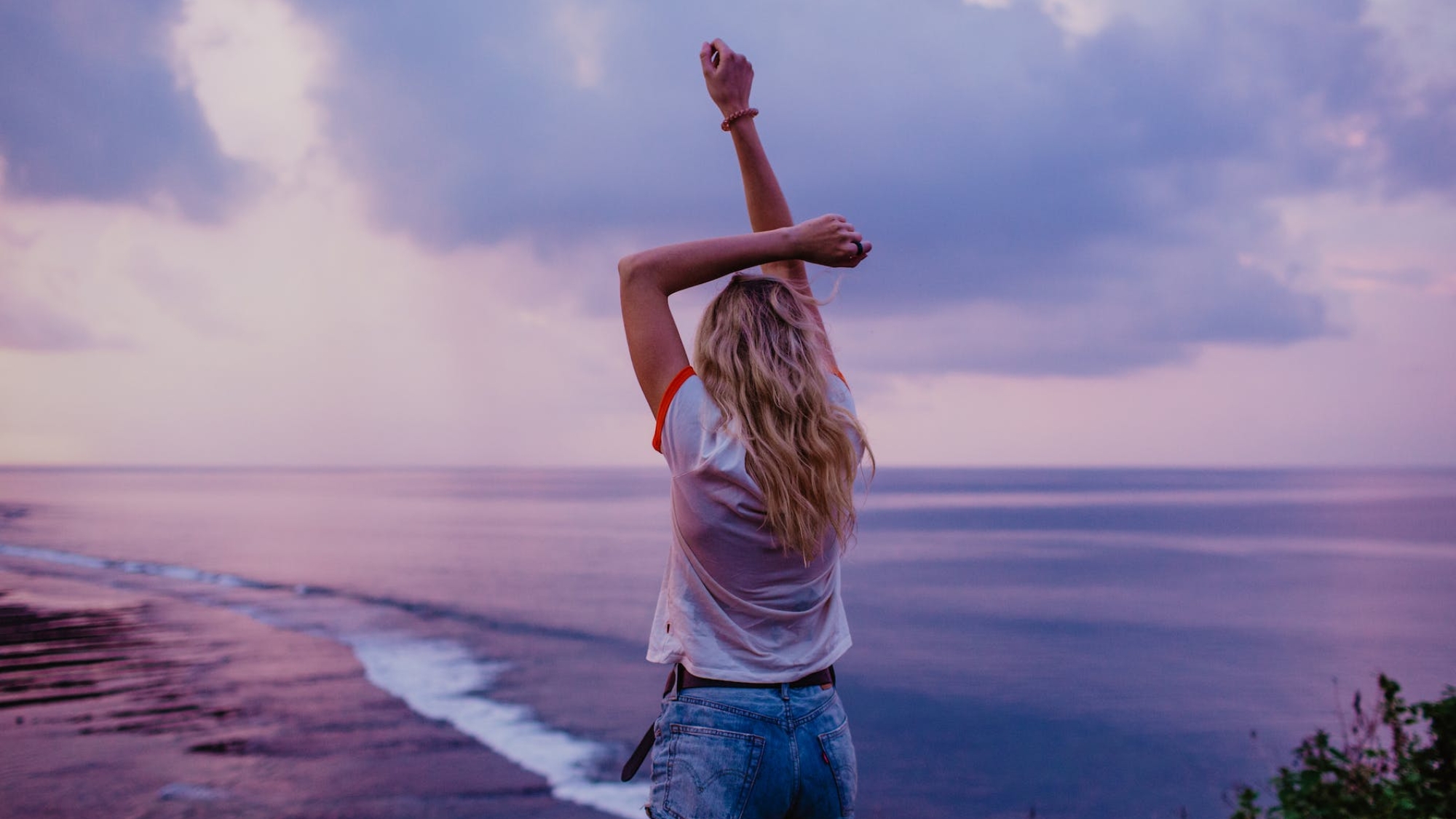 slim woman enjoying endless seascape on beach