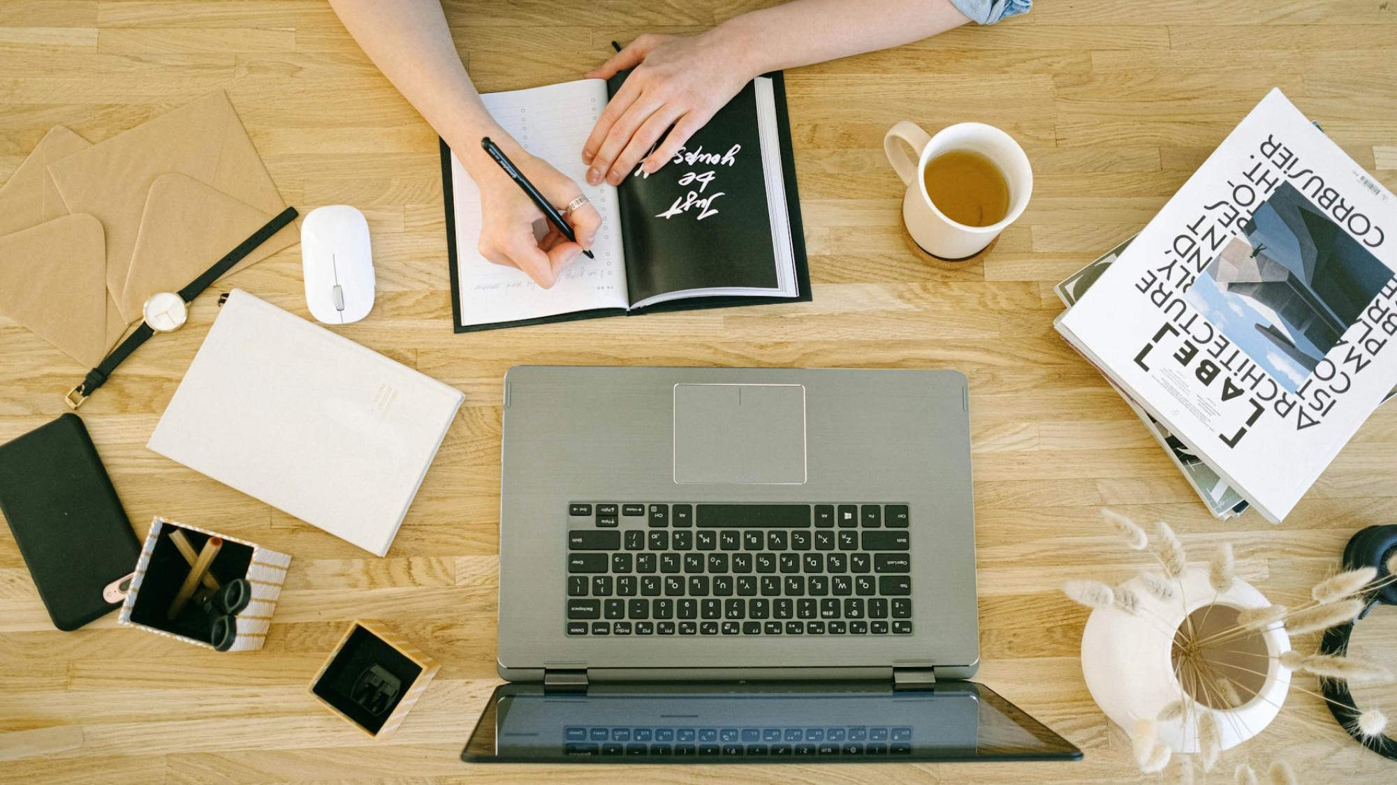 high angle view of woman writing in notebook