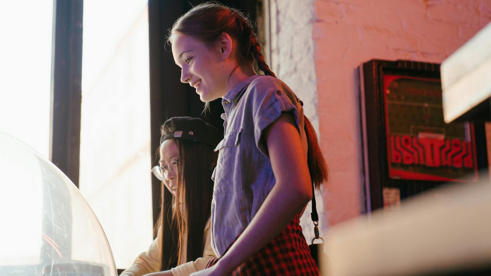 woman in blue denim vest and red and white plaid dress shirt sitting on chair